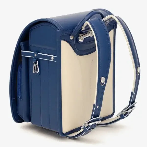 Bolca Randoseru – Leather by Murase Kabanko – blue and beige Japanese randoseru backpack with padded straps and metal buckle, side view.