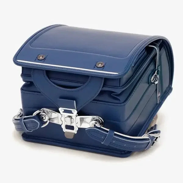 Bolca Randoseru – Leather by Murase Kabanko – navy blue Japanese Randoseru backpack with silver clasps and stitching, closed and upright.