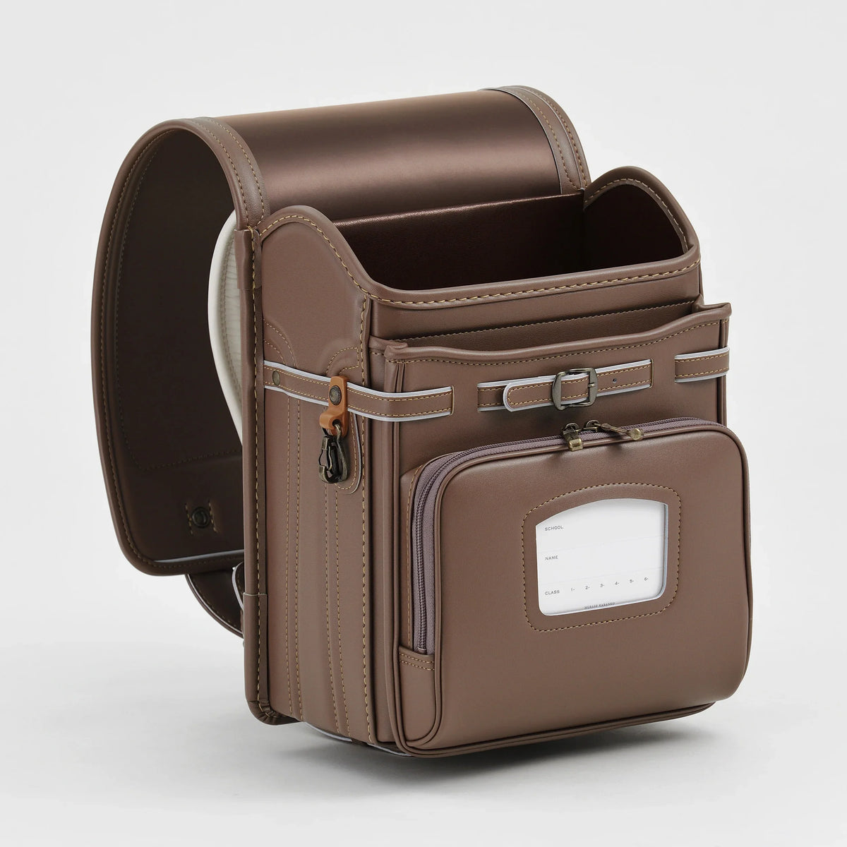 Bolca Randoseru by Murase Kabanko – brown Japanese randoseru backpack with front pocket and name tag, isolated on white