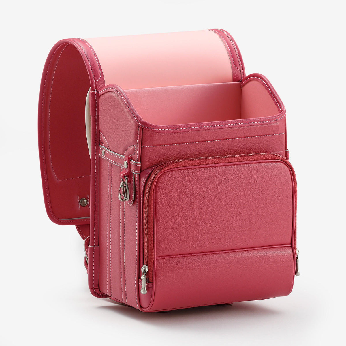 Bolca Randoseru – Leather by Murase Kabanko – pink Japanese randoseru backpack with structured shape and front pocket, isolated on white