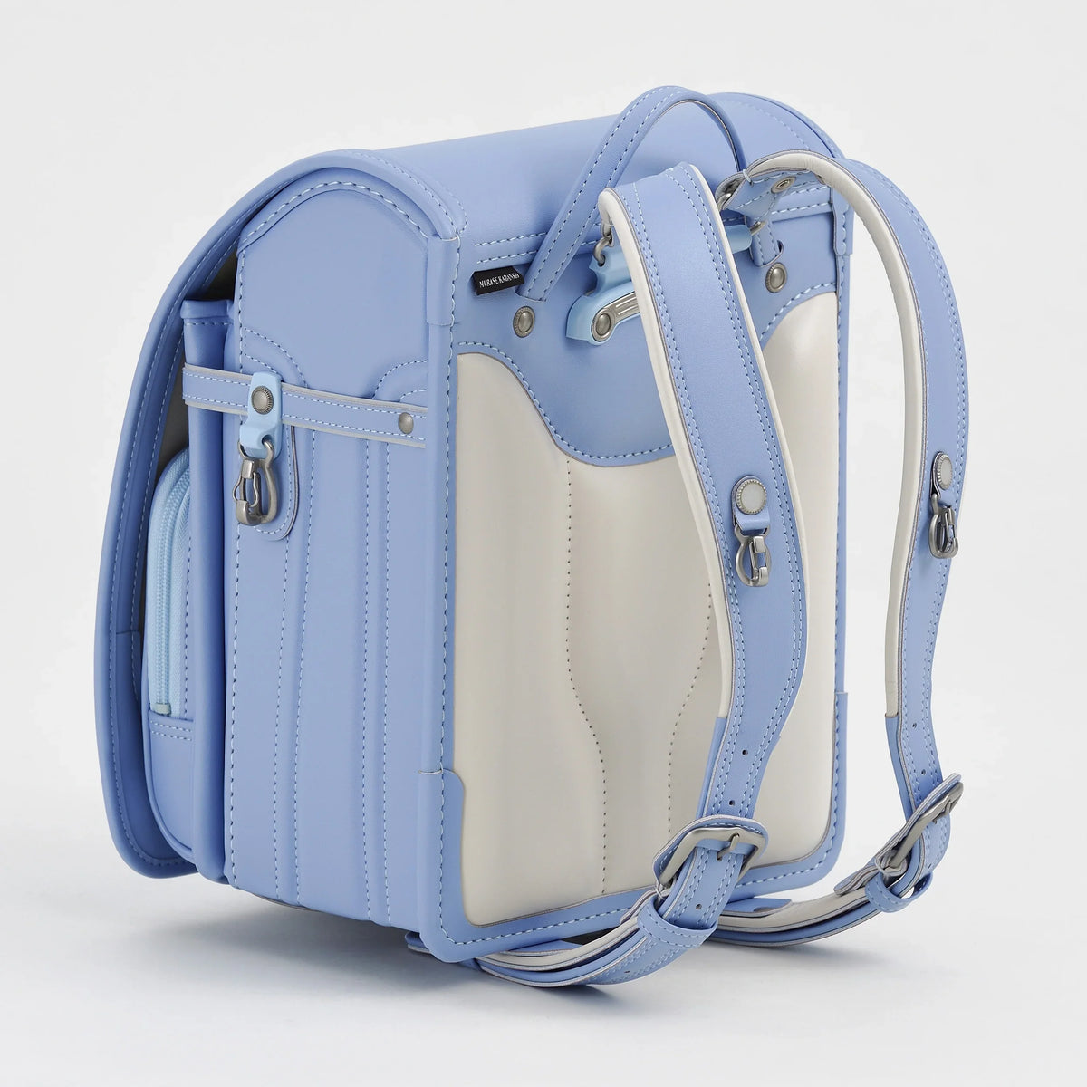 Bolca Randoseru by Murase Kabanko – light blue and white Japanese randoseru backpack with adjustable straps, side pocket, and metallic hardware.