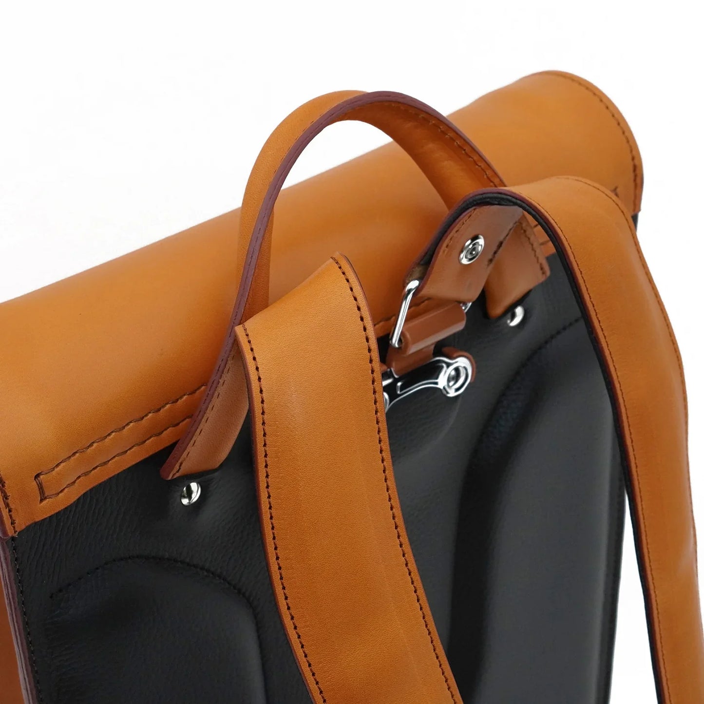 Detailed view of brown and black Japanese randoseru backpack leather straps and stitching