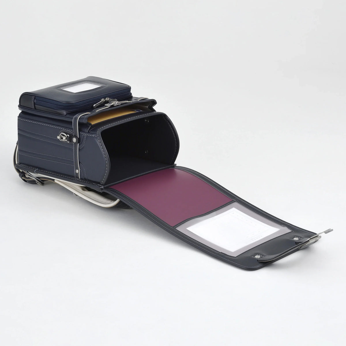 Bolca Randoseru by Murase Kabanko – open Japanese Randoseru backpack in navy blue with purple interior on white background