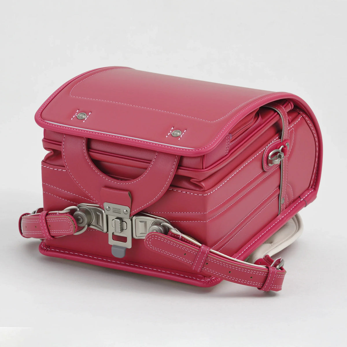 Bolca Randoseru by Murase Kabanko – pink Japanese randoseru backpack with white stitching and metal buckle, isolated on white background
