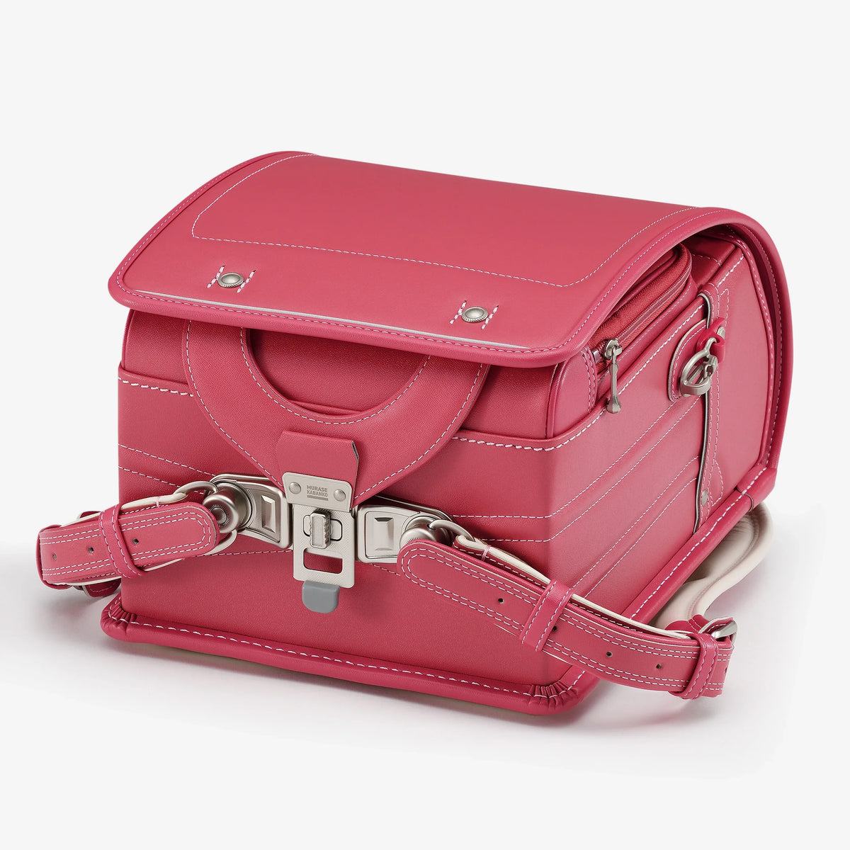 Bolca Randoseru – Leather by Murase Kabanko – pink Japanese Randoseru backpack with white stitching and metal hardware, angled view.