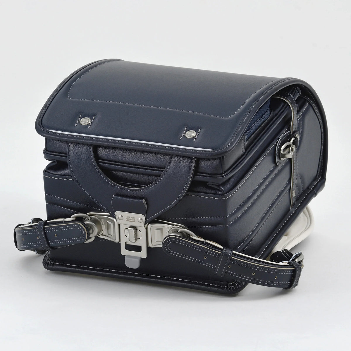 Bolca Randoseru by Murase Kabanko – navy blue Japanese randoseru backpack with white stitching and metal clasp on white background