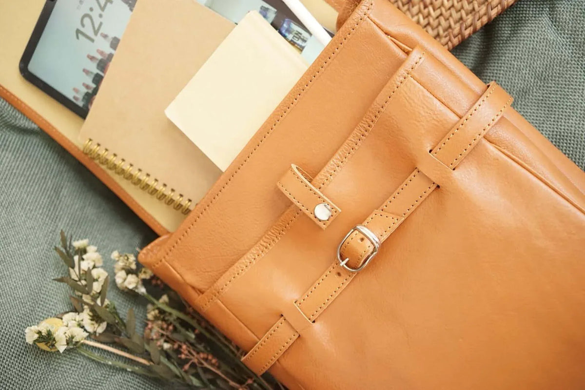 Sofurilla Adult Randoseru by Murase Kabanko – tan Japanese Randoseru backpack with notebooks, tablet, and flowers on a green fabric