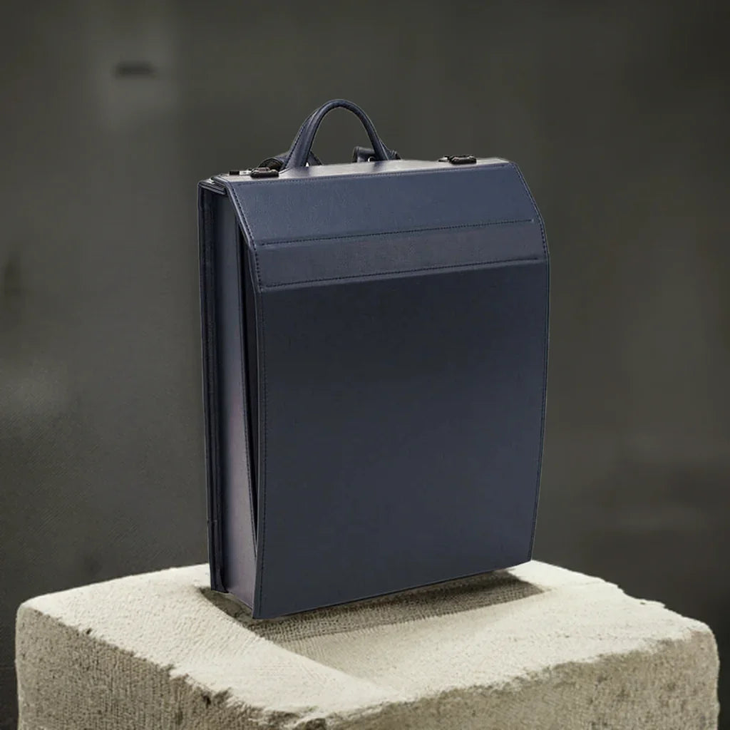 VIR Adults Randoseru by Murase Kabanko – navy blue Japanese randoseru backpack on textured beige pedestal, minimalist background