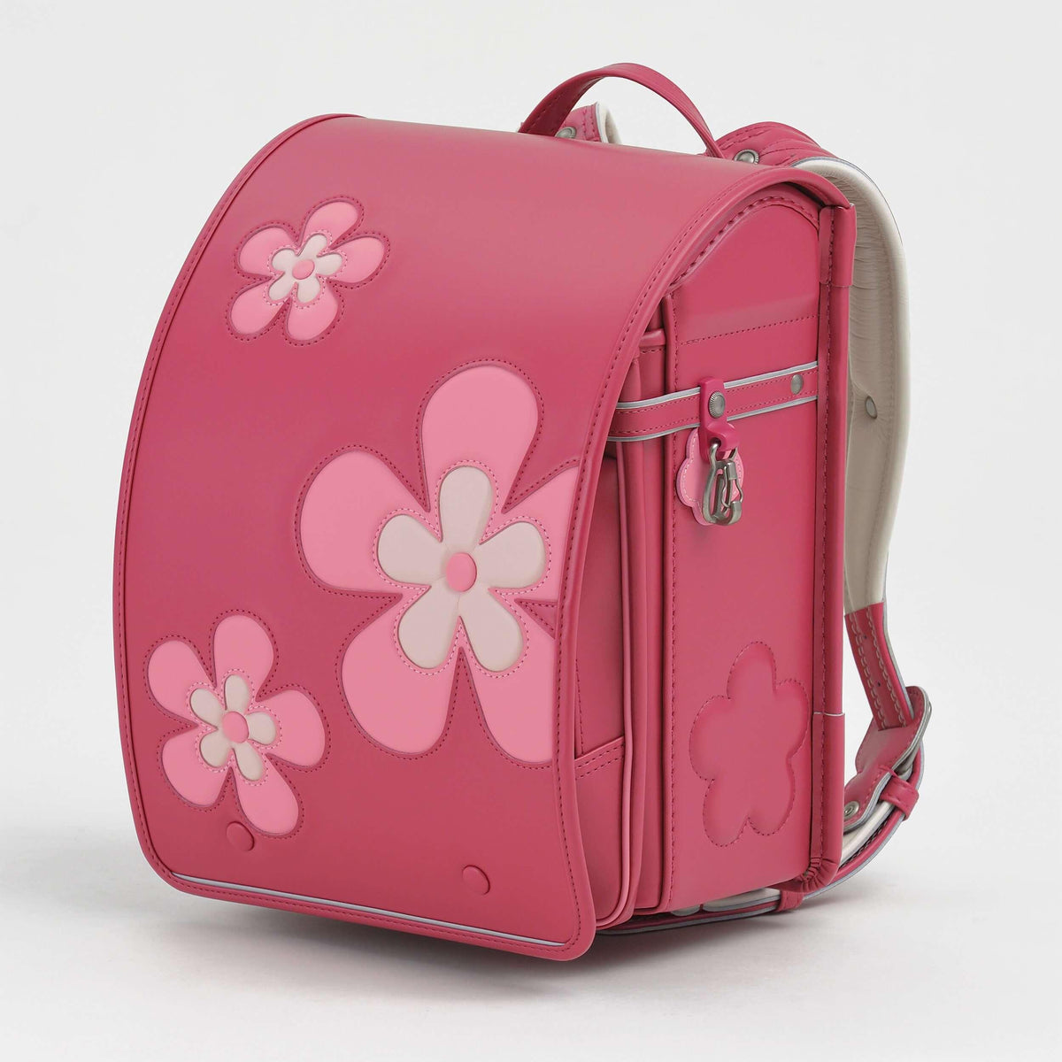 Huo Randoseru by Murase Kabanko – pink Japanese Randoseru backpack with large flower appliqué, side view on white background