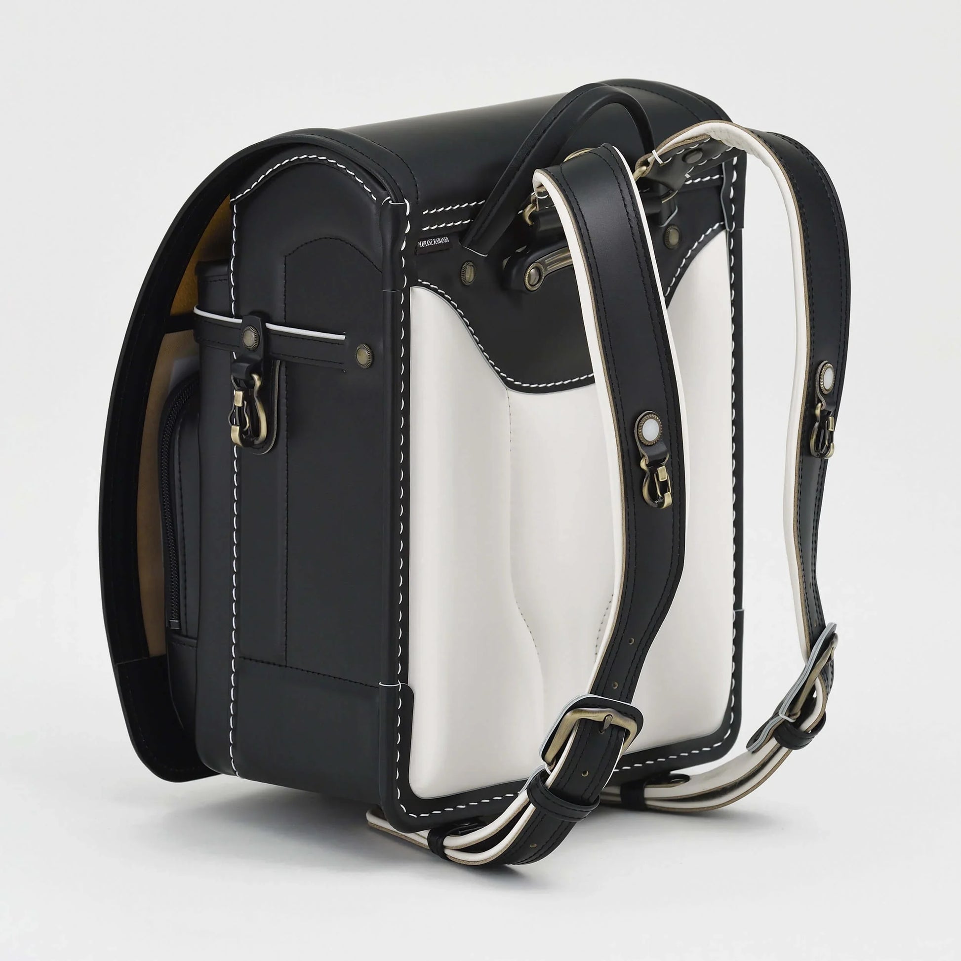 Premium Randoseru Takumi backpack in black with white panels, padded straps, and contrast stitching by Murase Kabanko