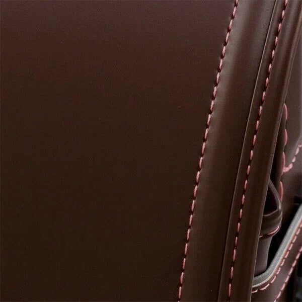 Close-up of brown Japanese randoseru backpack with pink stitching and leather texture