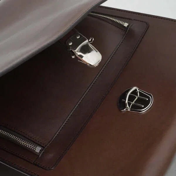 Close-up of brown leather Japanese randoseru schoolbag with metal clasp and zipper detail