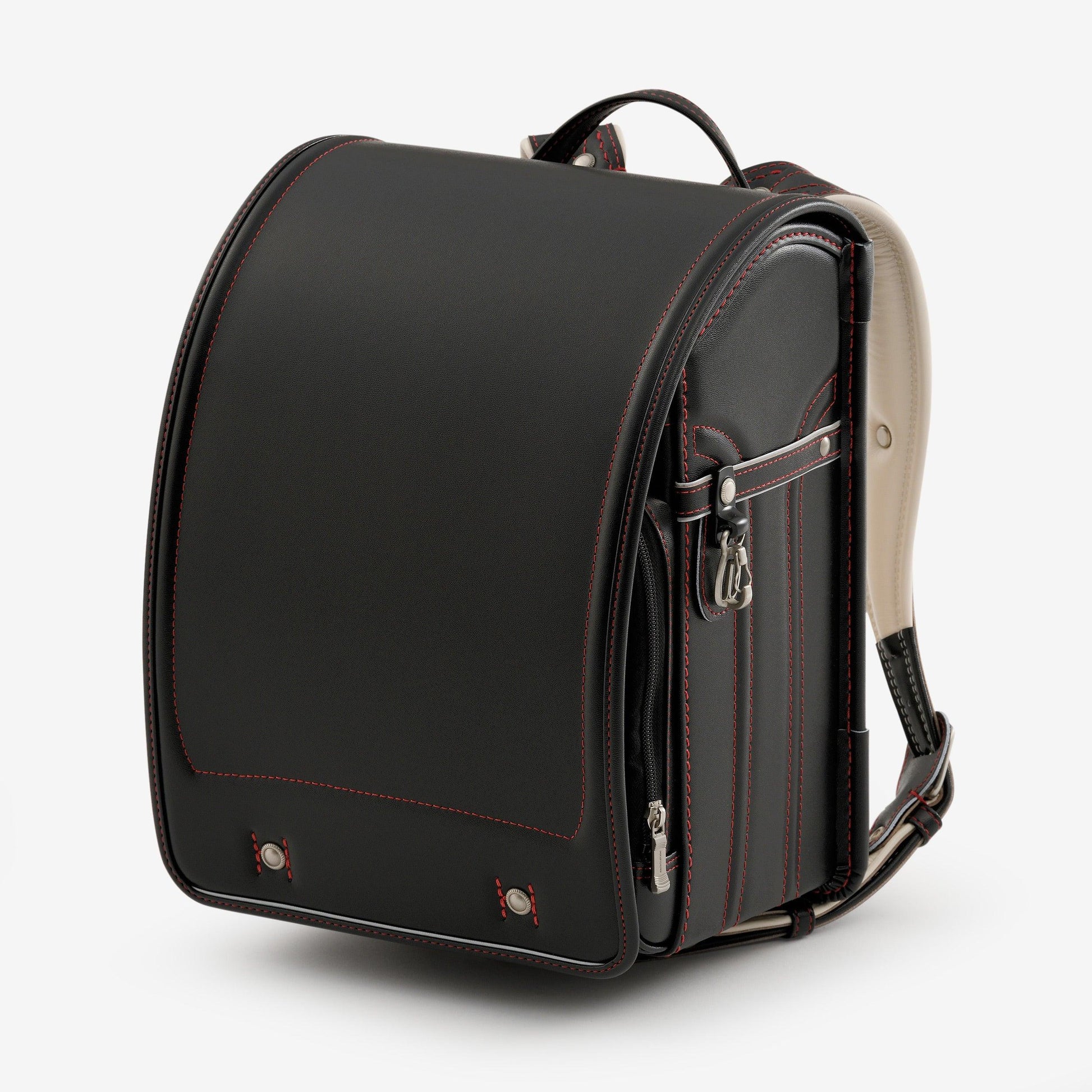 Black Japanese randoseru backpack with red stitching and metal accents on white background