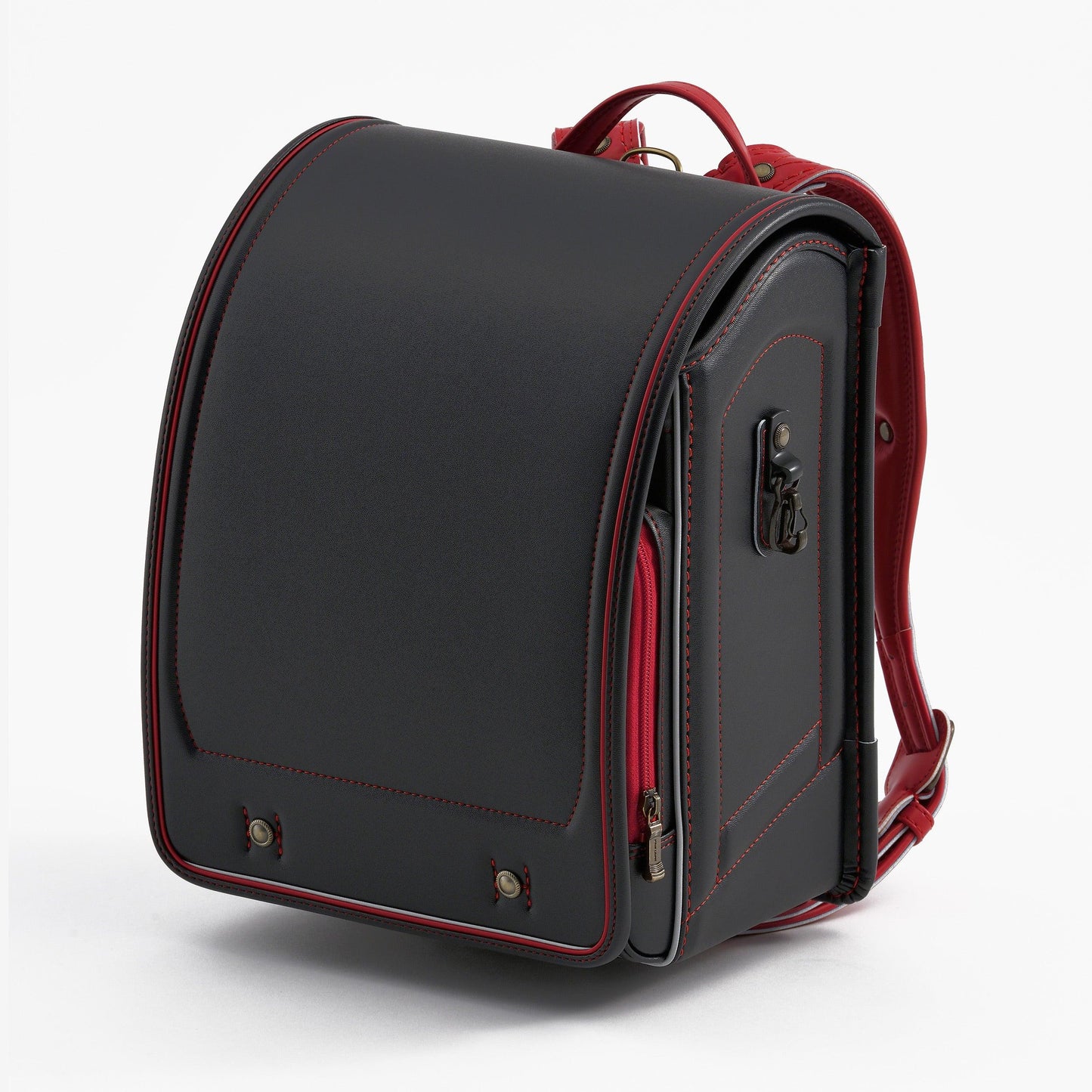 Black Japanese randoseru backpack with red accents and sturdy structure on white background