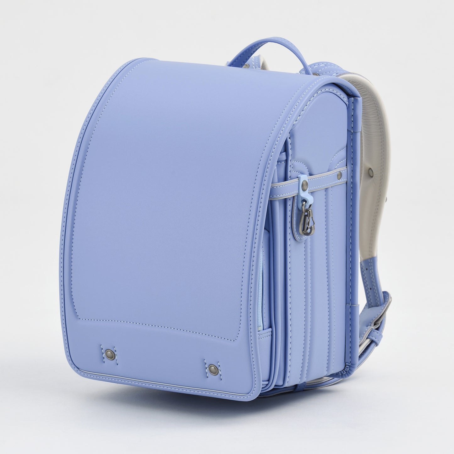 Light blue Japanese randoseru backpack with metal clasp and sturdy structure on white background