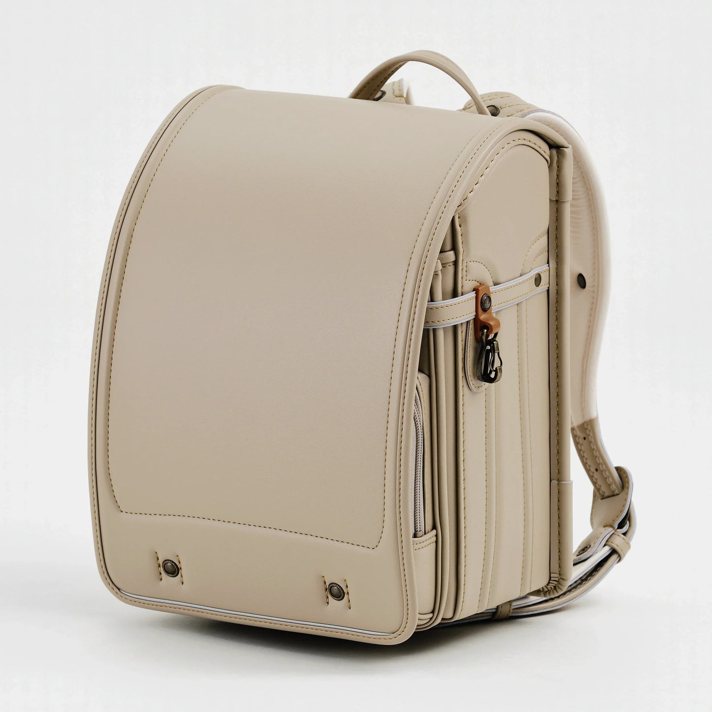 Beige Japanese Randoseru backpack with structured design, side pocket, and top handle