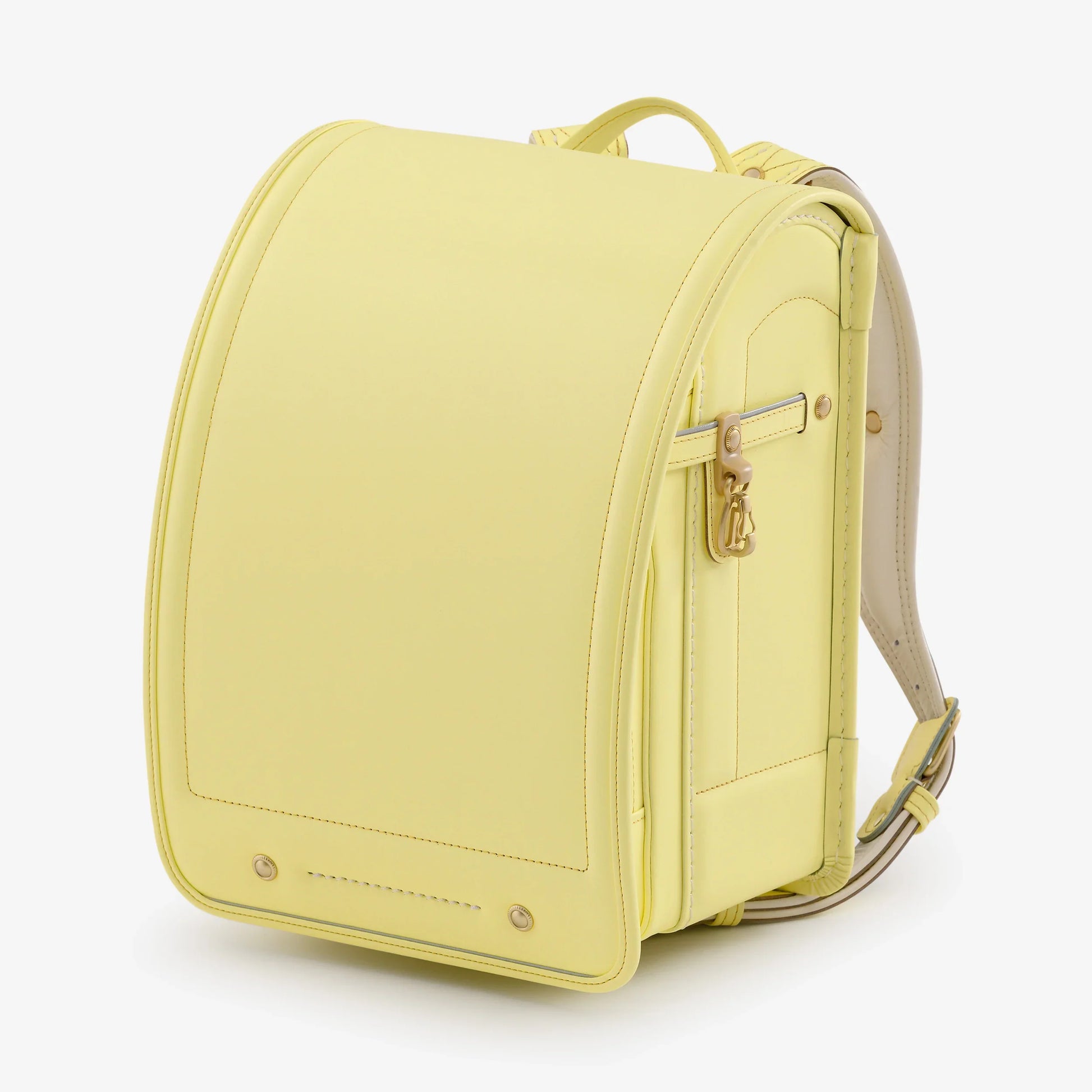 Light yellow Japanese randoseru backpack with leather straps and metal clasp