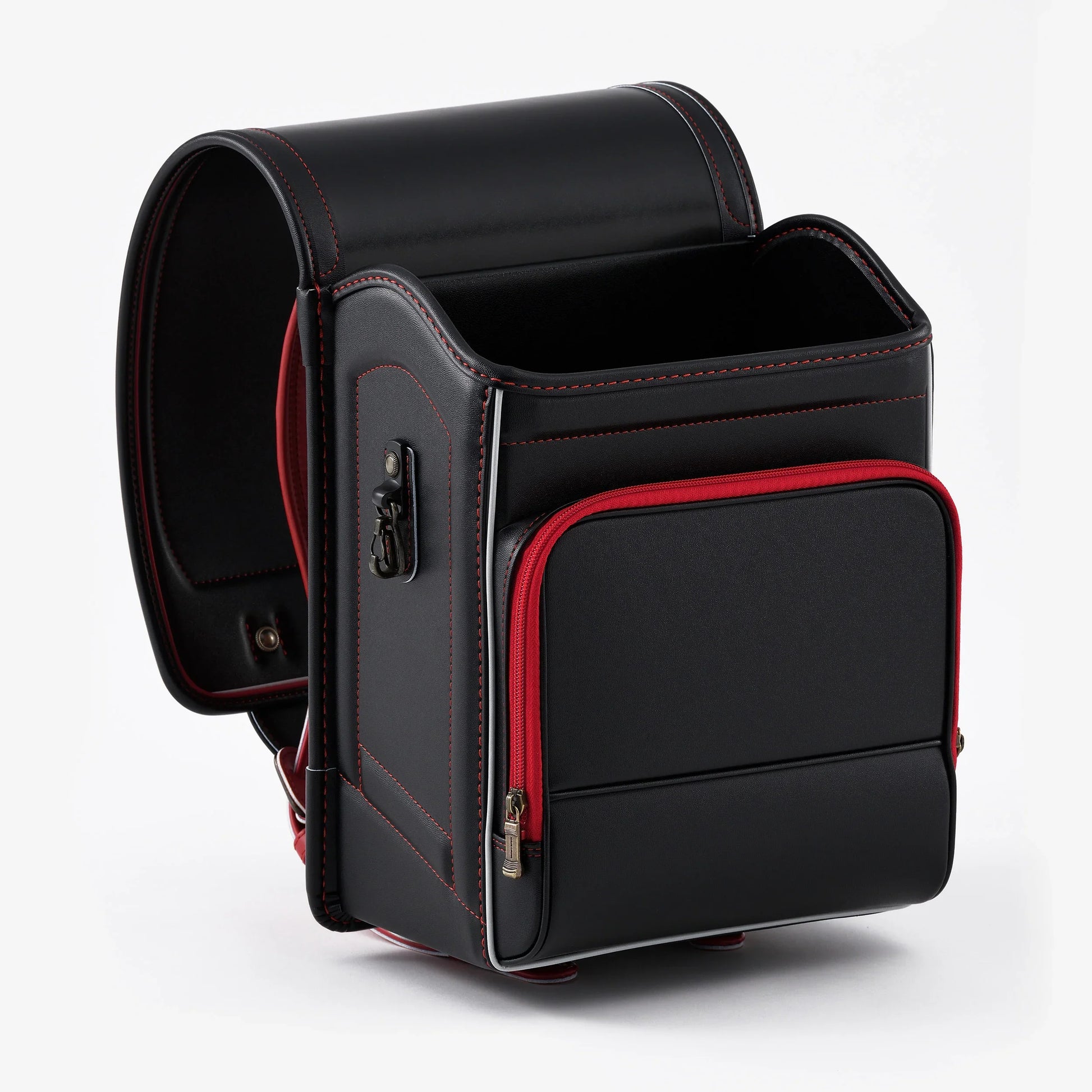 Black Japanese randoseru backpack with red trim, front pocket, and red stitching