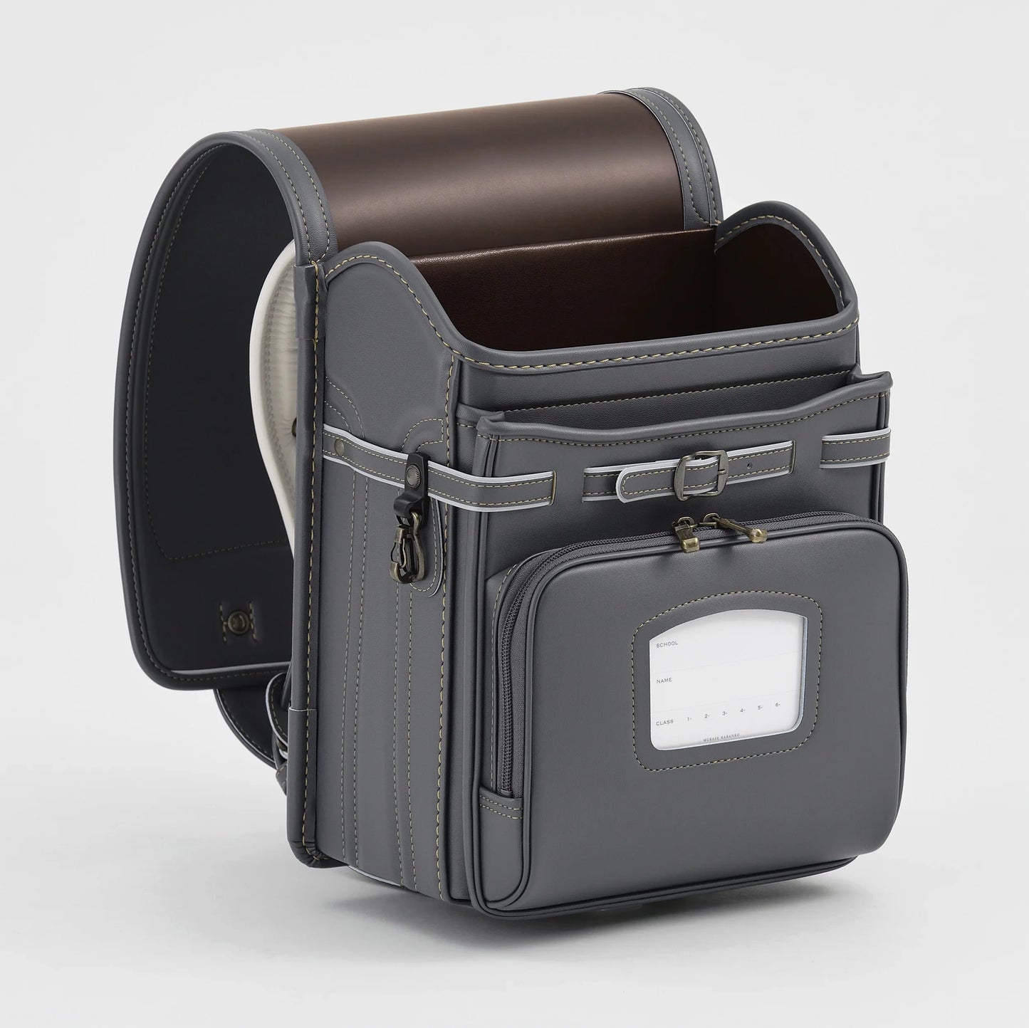 Gray Japanese randoseru backpack with front pocket and brown interior on white background