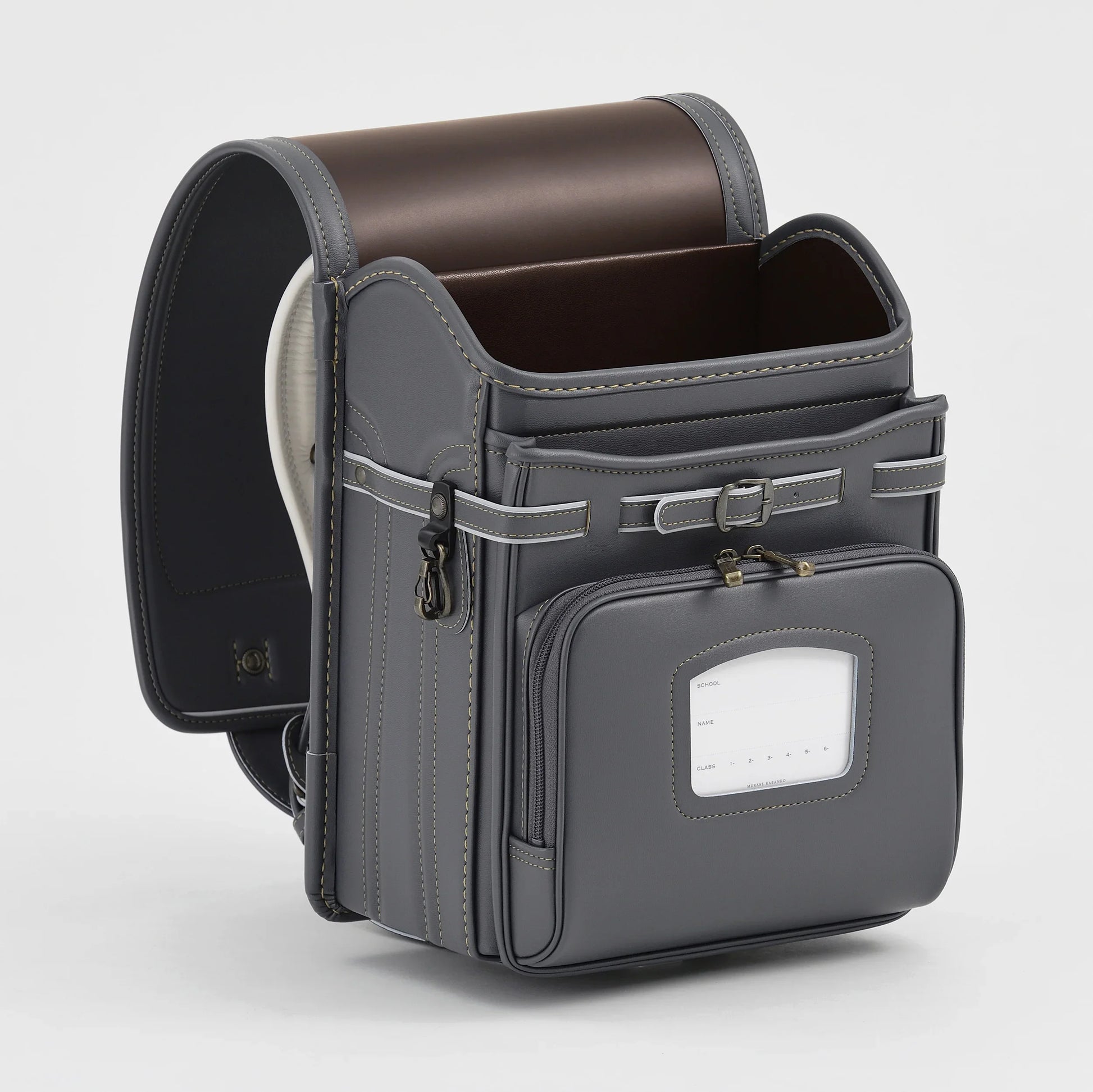 Gray Japanese randoseru backpack with front pocket and brown interior on white background
