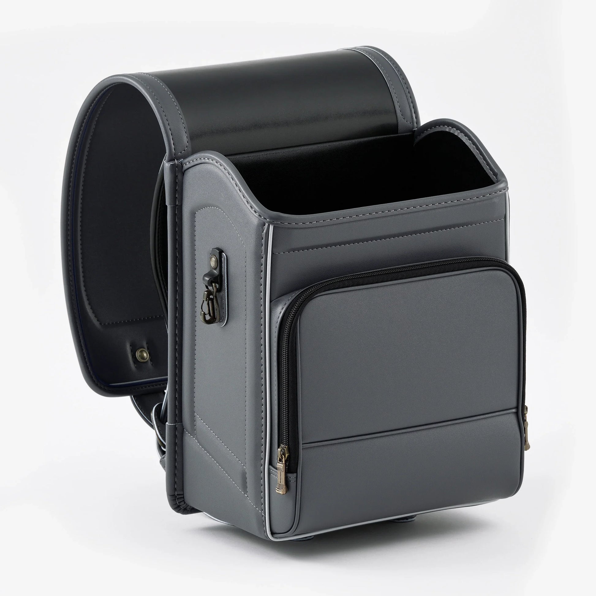 Gray Japanese Randoseru backpack with boxy shape and front zipper pocket on white background.