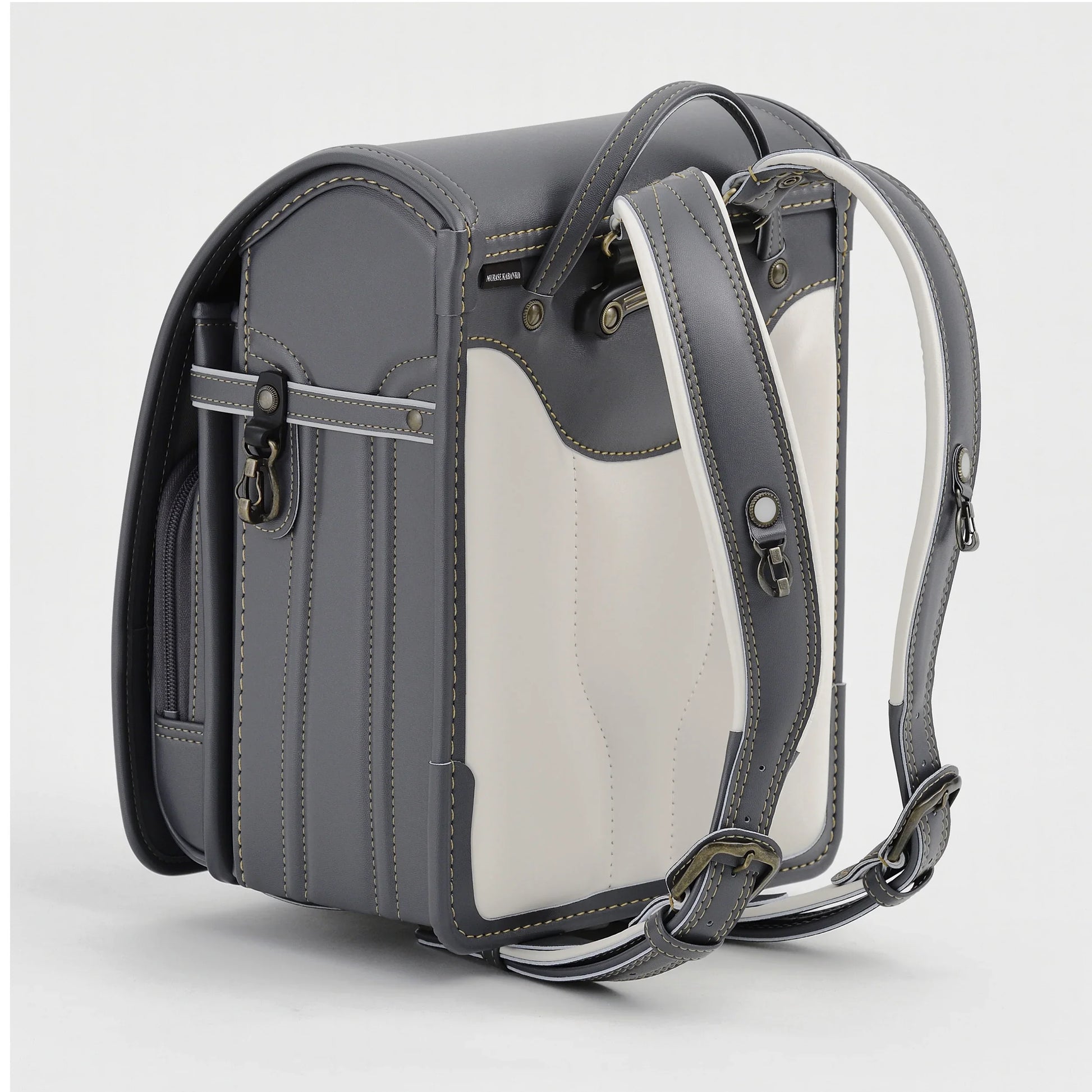 Gray and white Japanese randoseru backpack with adjustable straps, classic kids school bag
