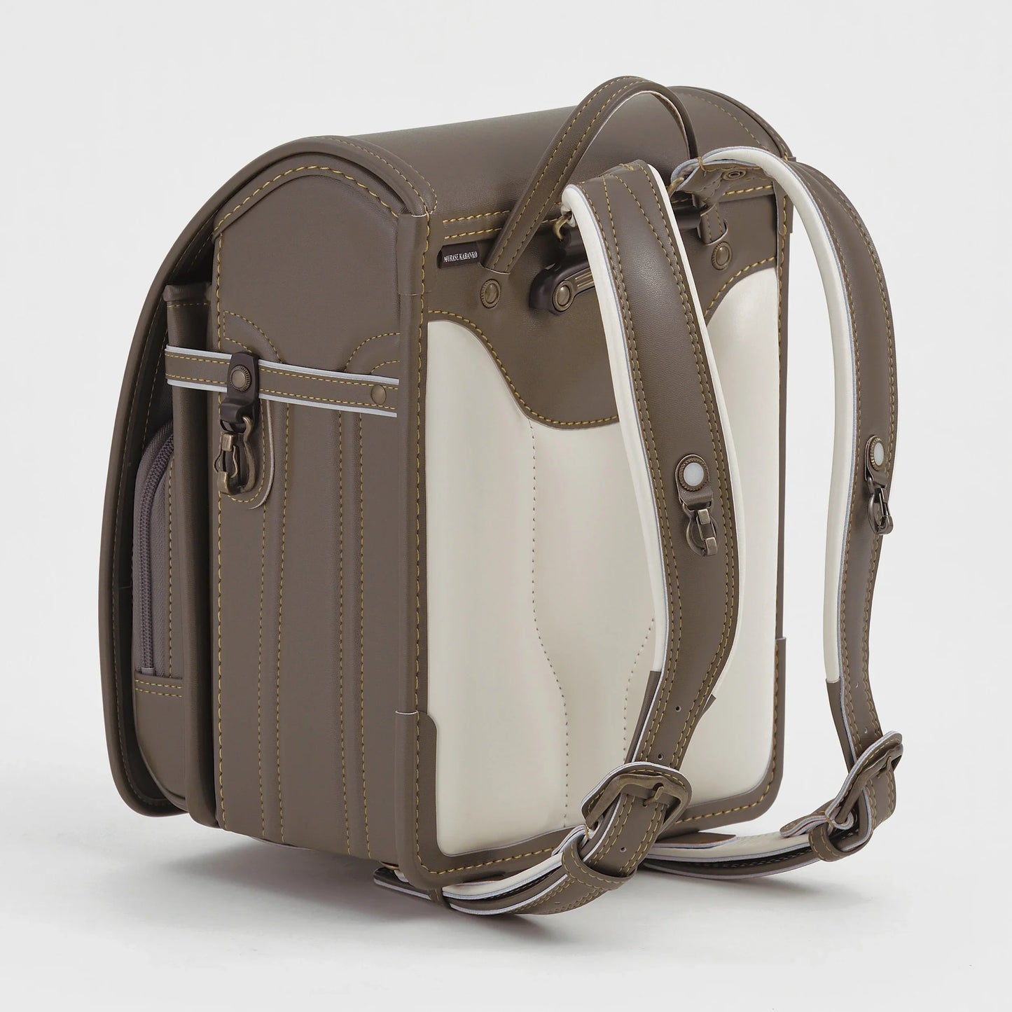 Japanese randoseru backpack in taupe and cream with adjustable shoulder straps, side pocket