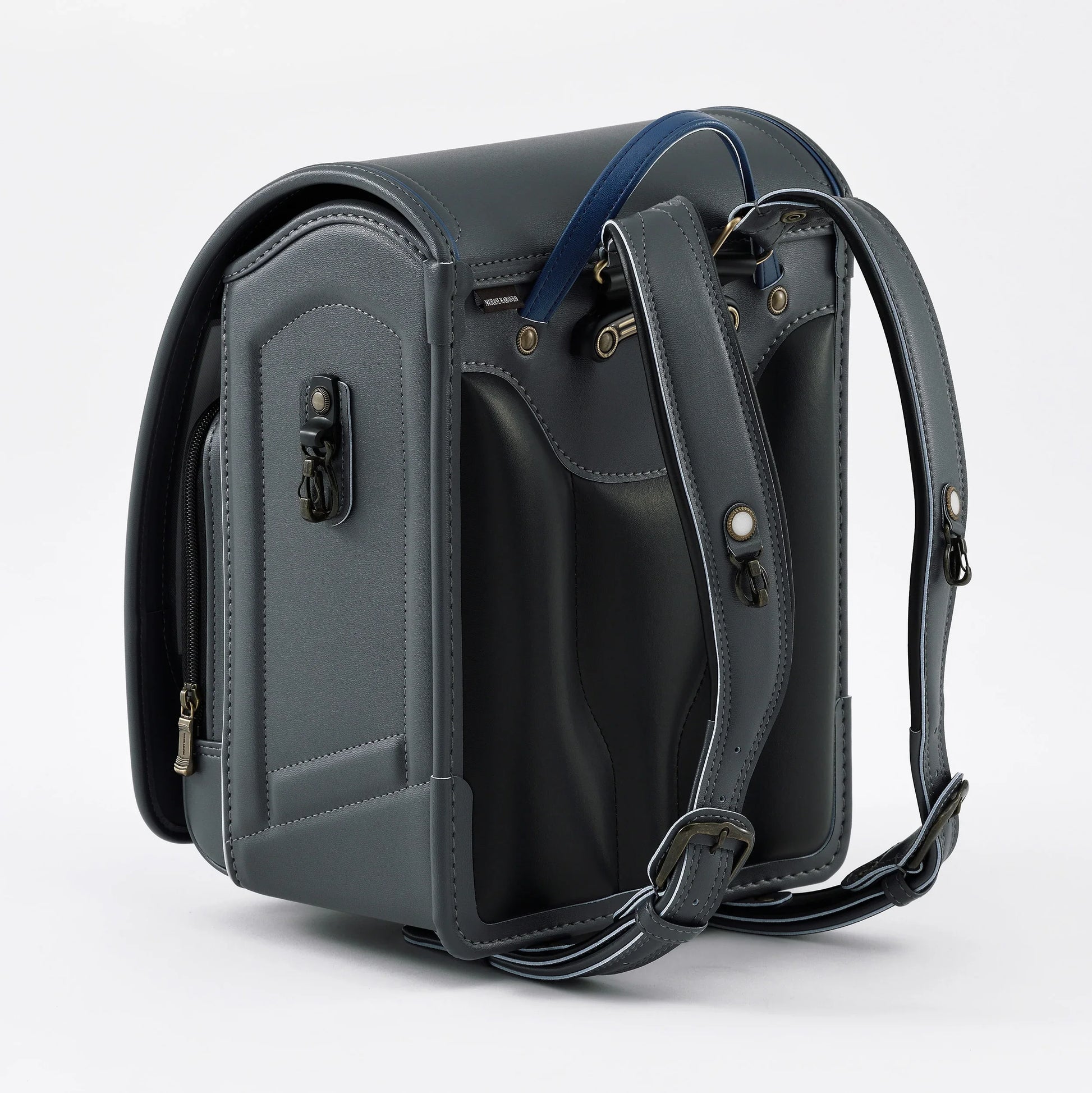 Gray Japanese randoseru backpack with blue handle, detailed stitching, and adjustable straps