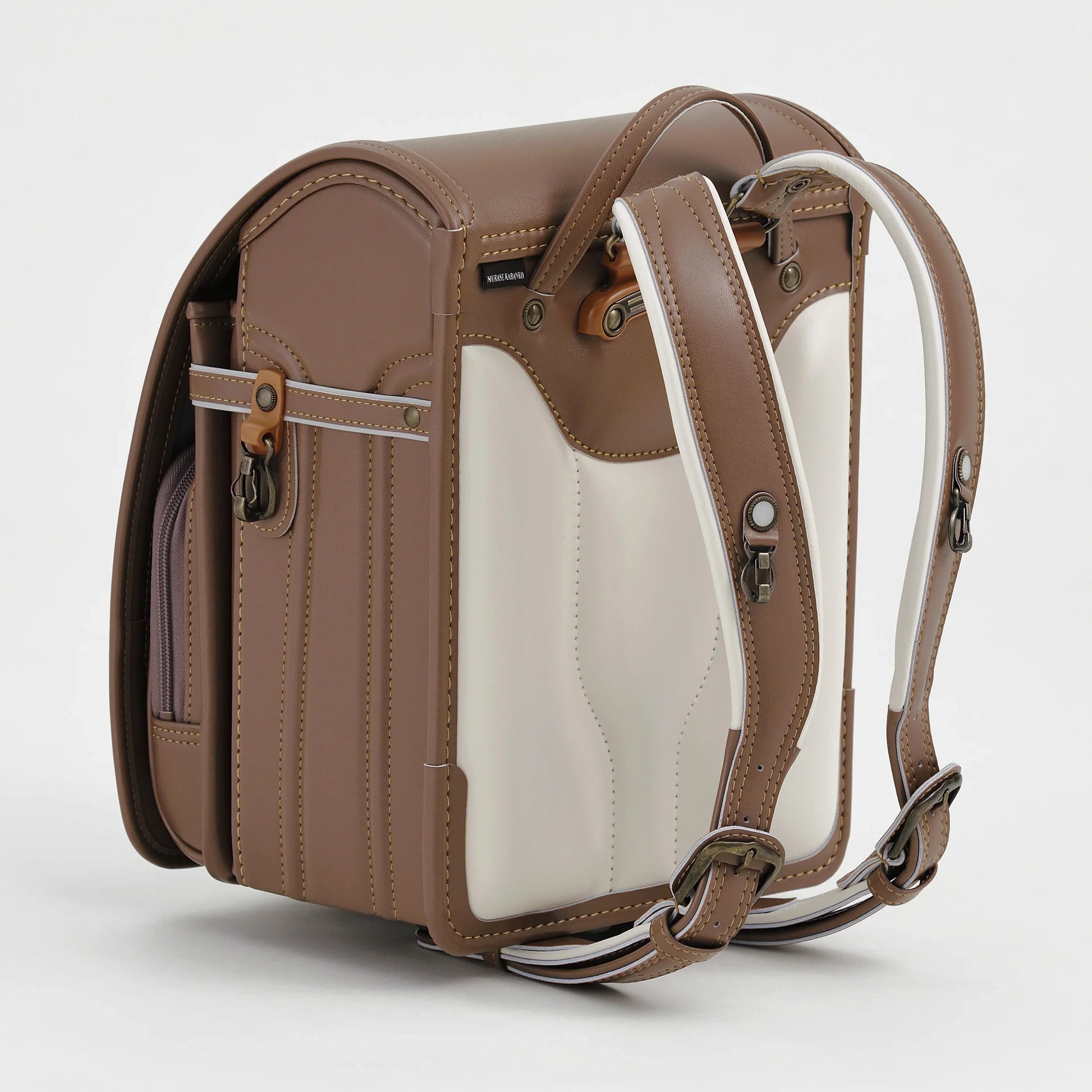 Brown and cream Japanese randoseru backpack with adjustable straps, ergonomic design