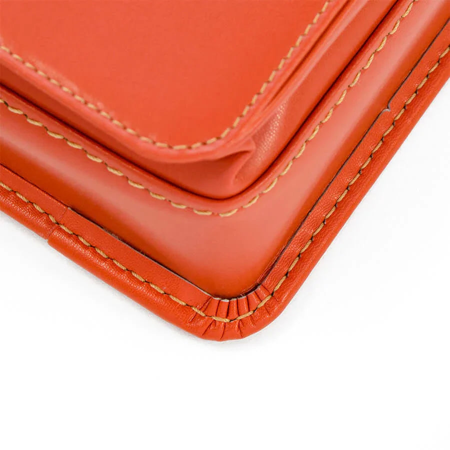 Murase Kabanko mini randoseru backpack in orange leather with tan stitching at the corner