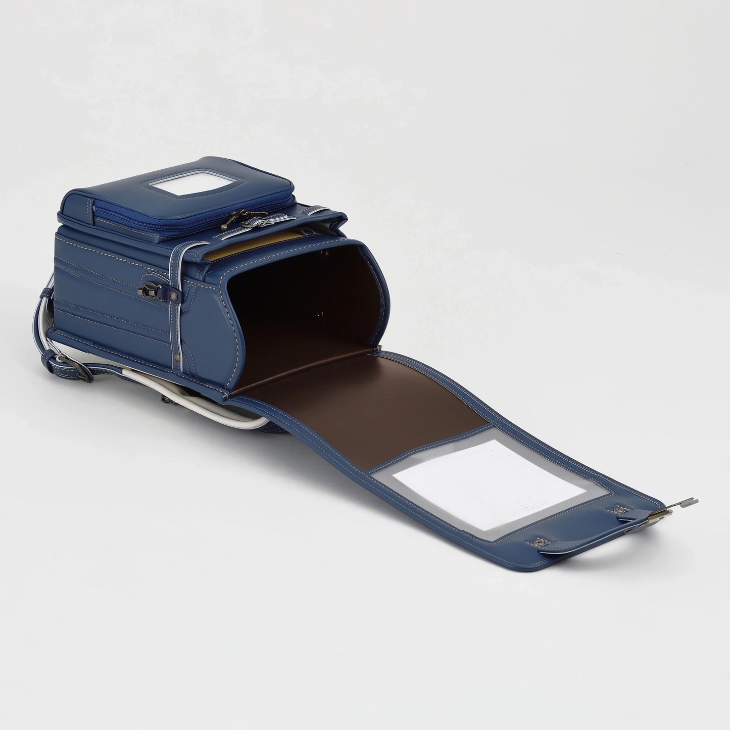 Blue Japanese Randoseru backpack open with visible compartments on white background