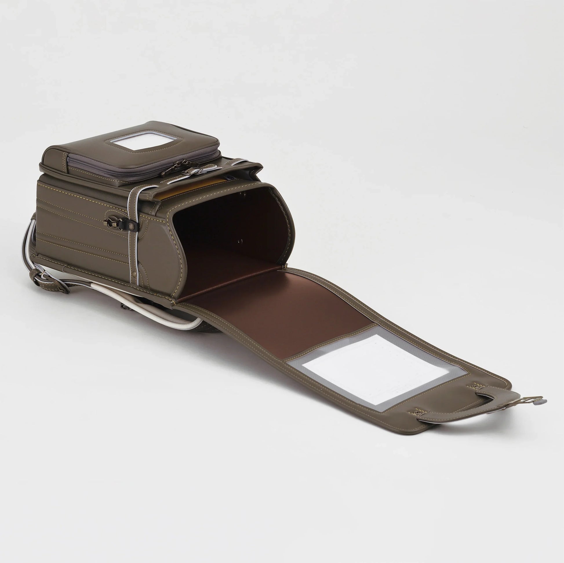 Olive green Japanese randoseru backpack open with visible interior compartments on white background