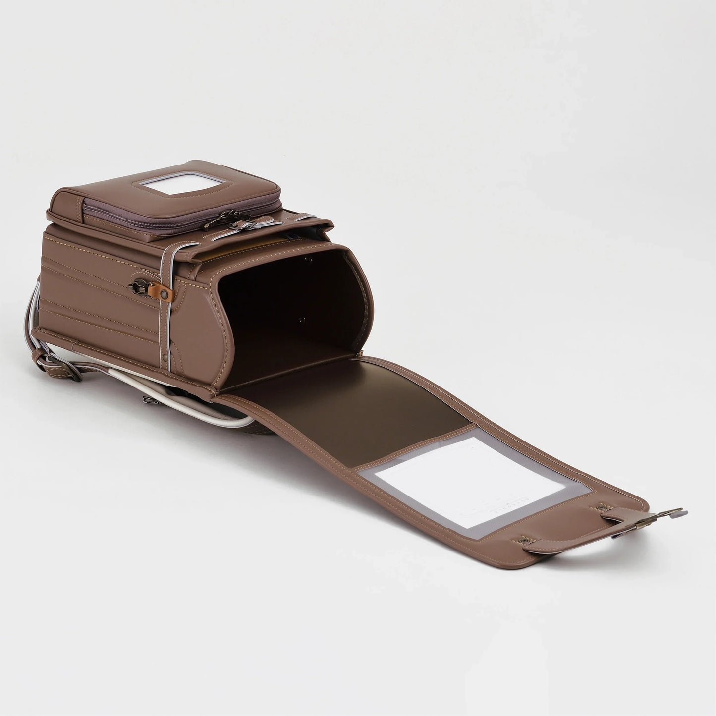 Brown Japanese randoseru backpack open on white background, premium leather school bag