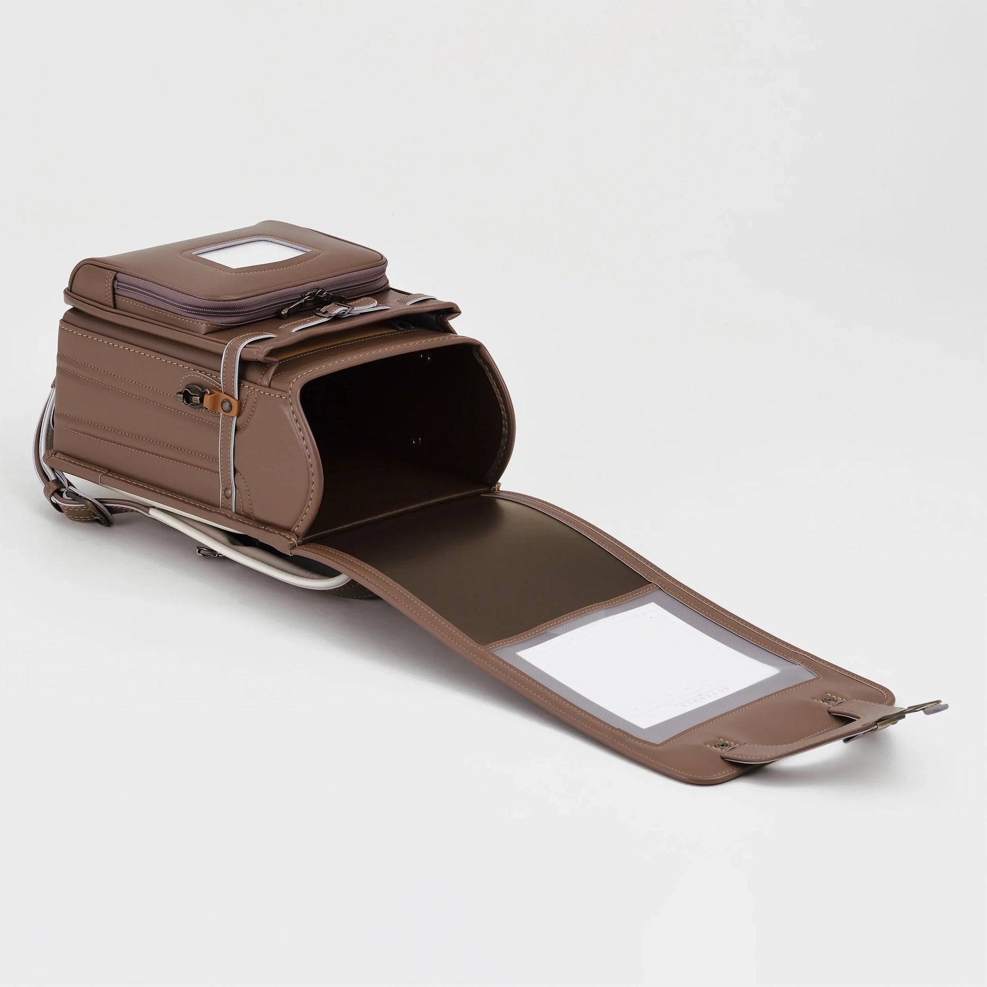 Brown Japanese randoseru backpack open on white background, premium leather school bag