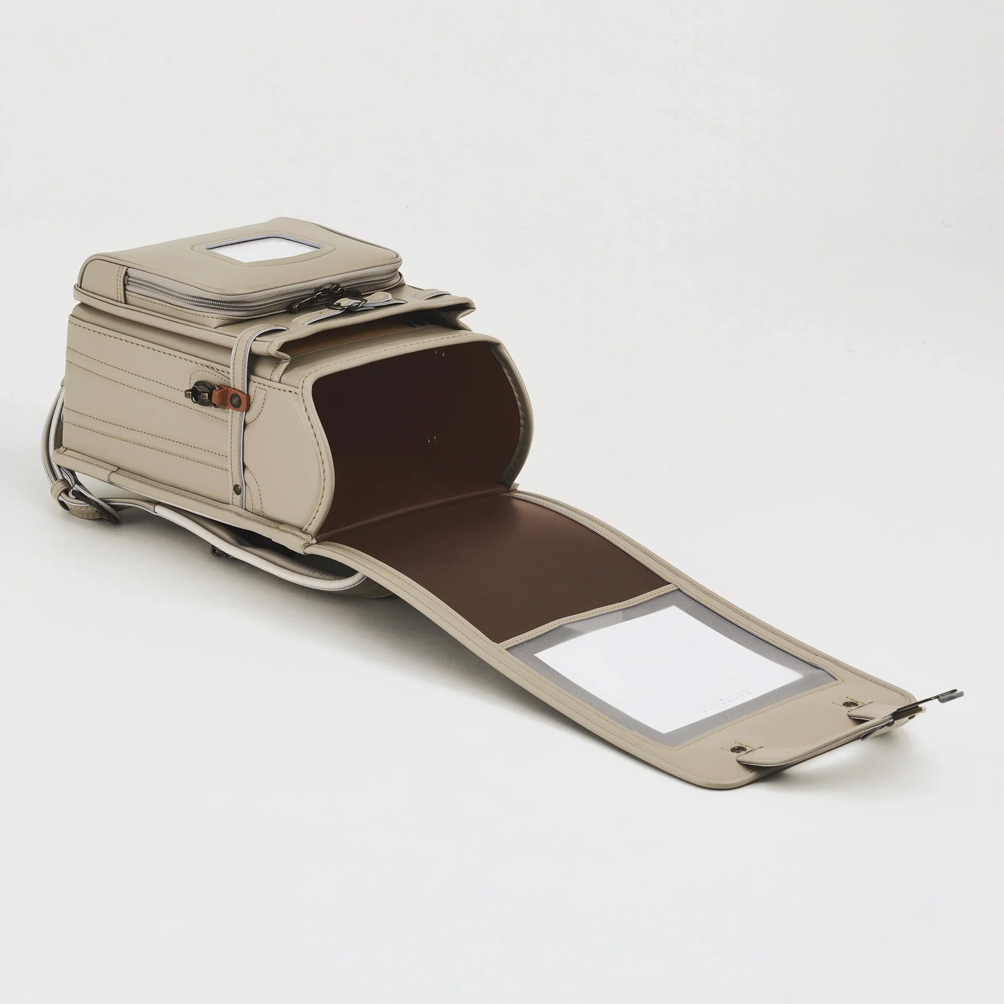 Beige Japanese randoseru backpack open, showing spacious interior and sturdy leather design
