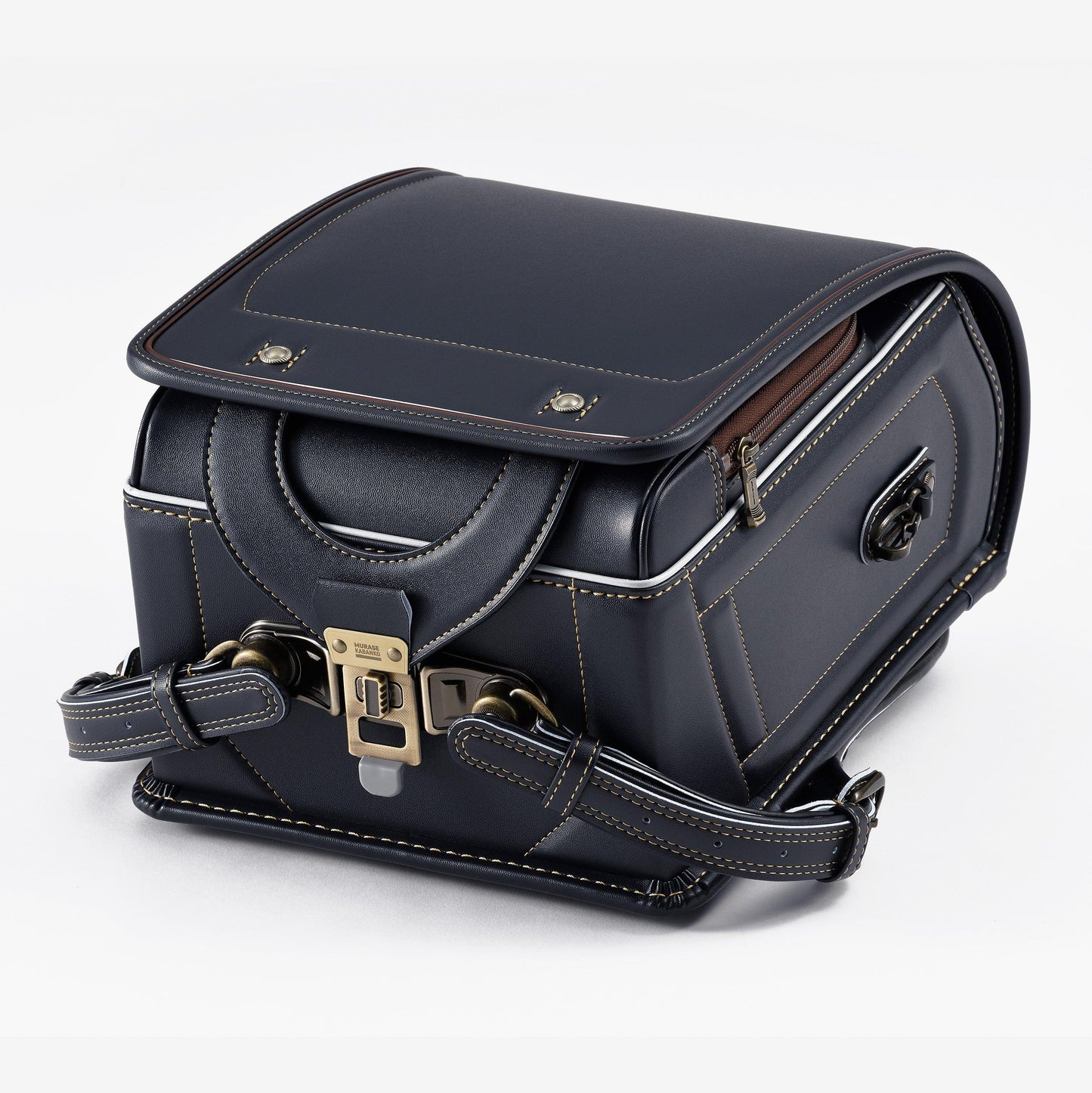Navy Japanese randoseru backpack with tan stitching and metal clasp on white background