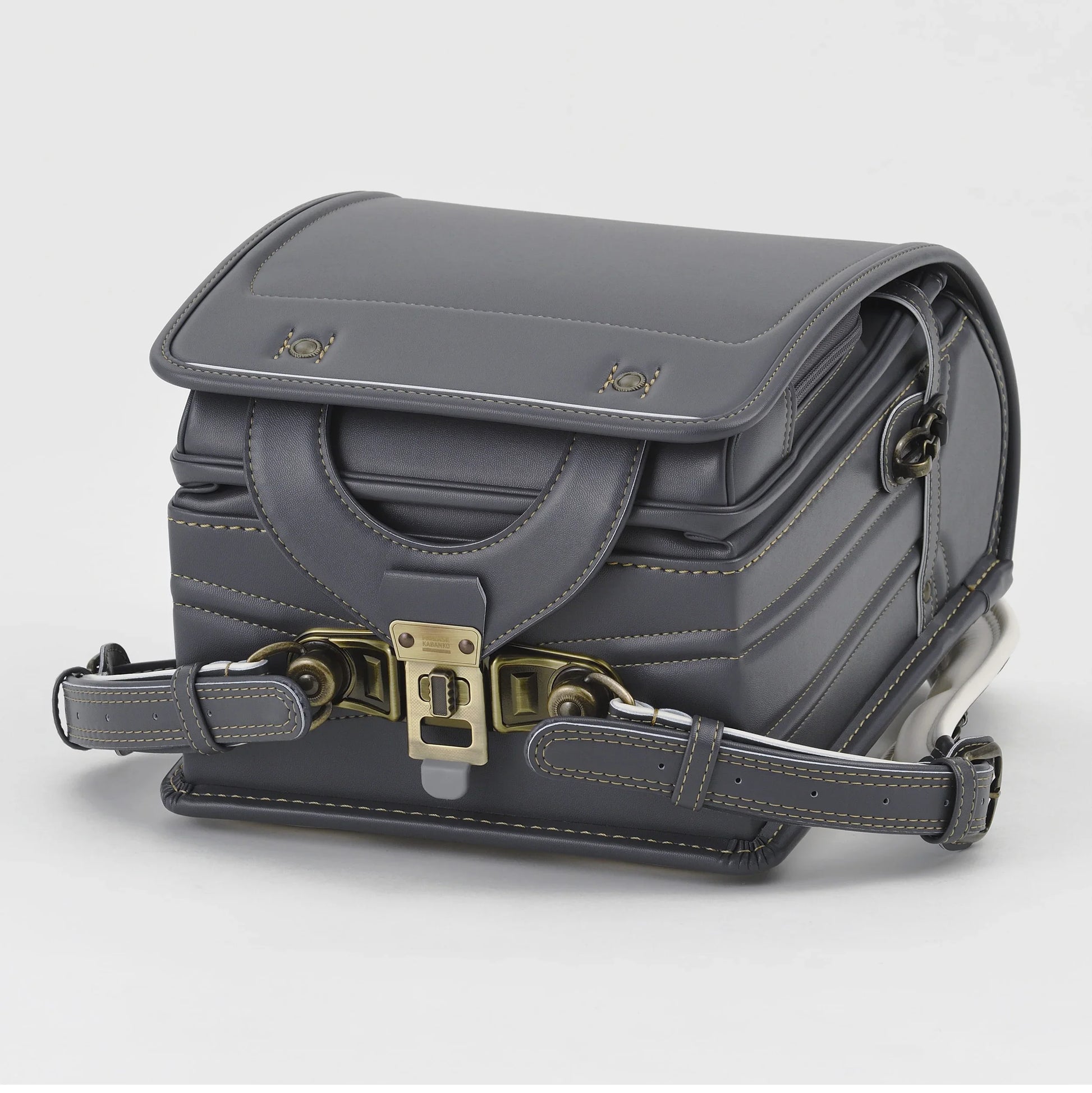 Dark gray Japanese Randoseru backpack with brass hardware and detailed stitching