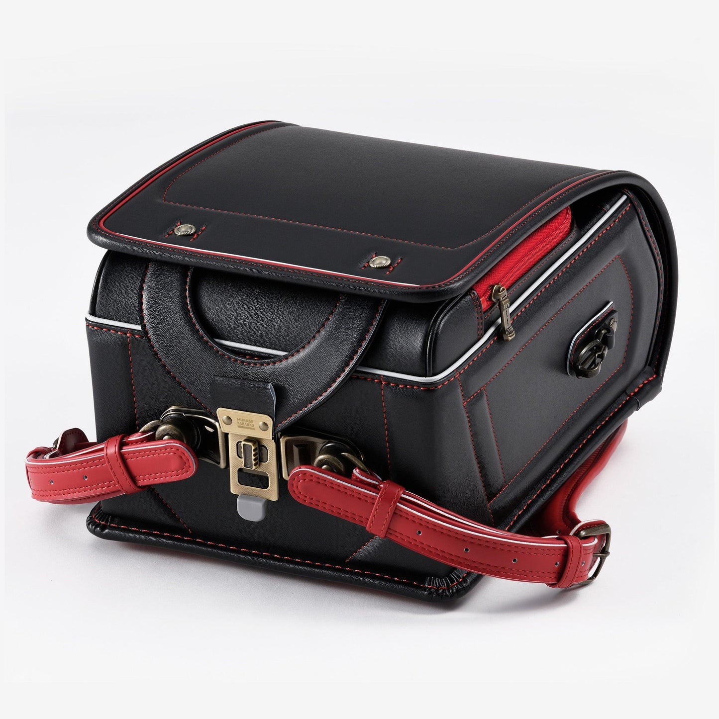 Black Japanese randoseru backpack with red stitching and red straps on white background