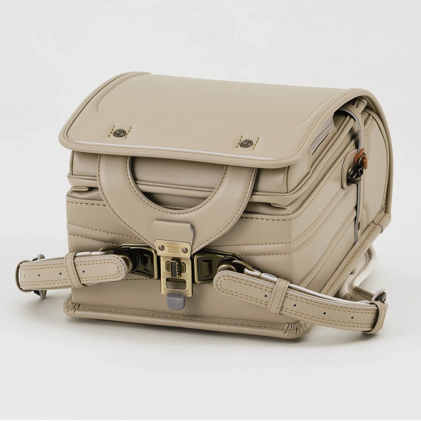 Beige Japanese randoseru backpack with metal clasp, shown from the front on white background