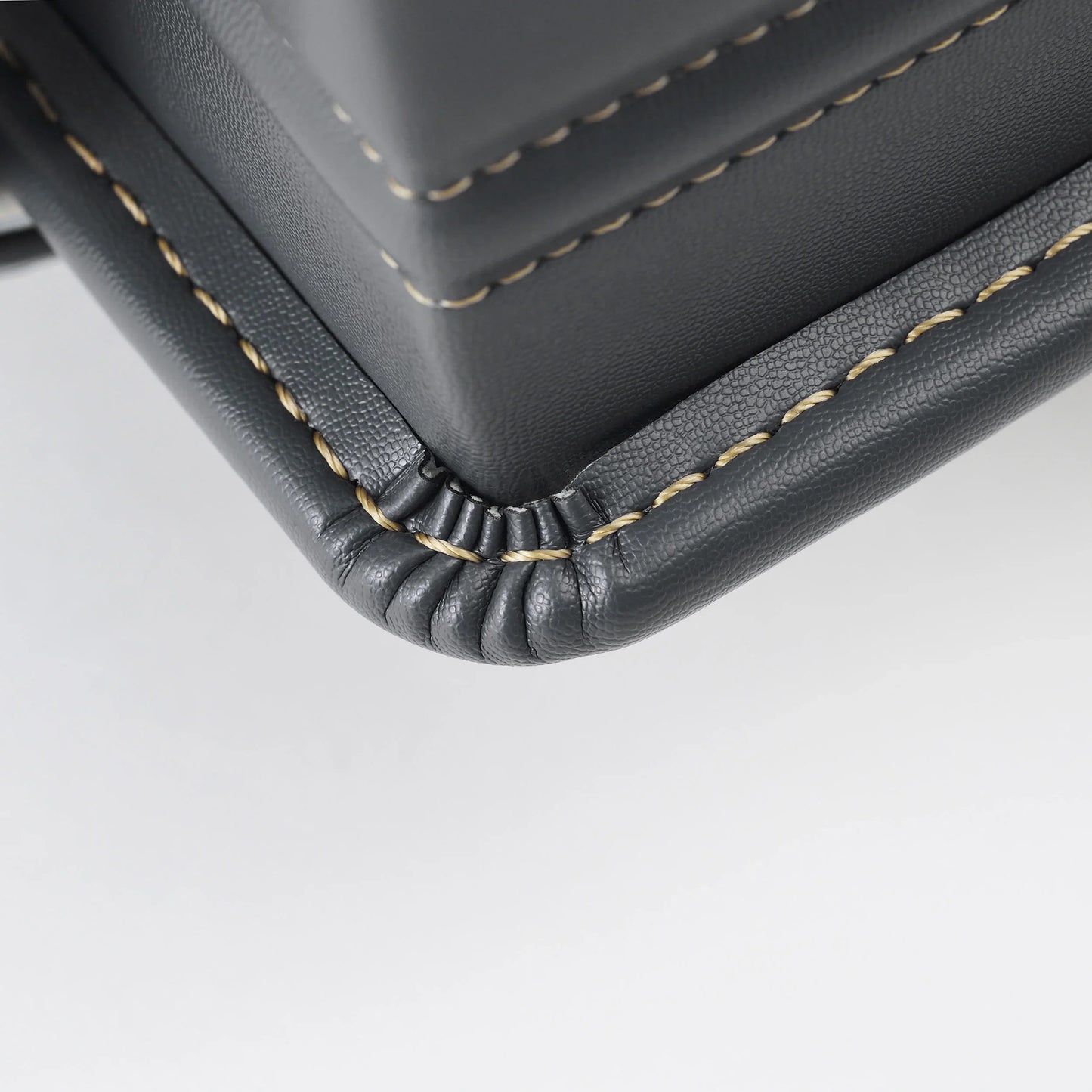 Detailed close-up of black Japanese randoseru backpack corner with fine stitching