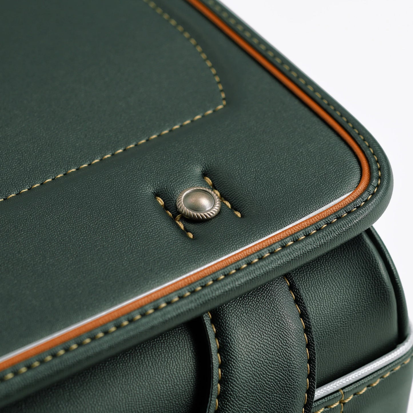 Close-up of green Japanese randoseru backpack with brown trim and detailed stitching
