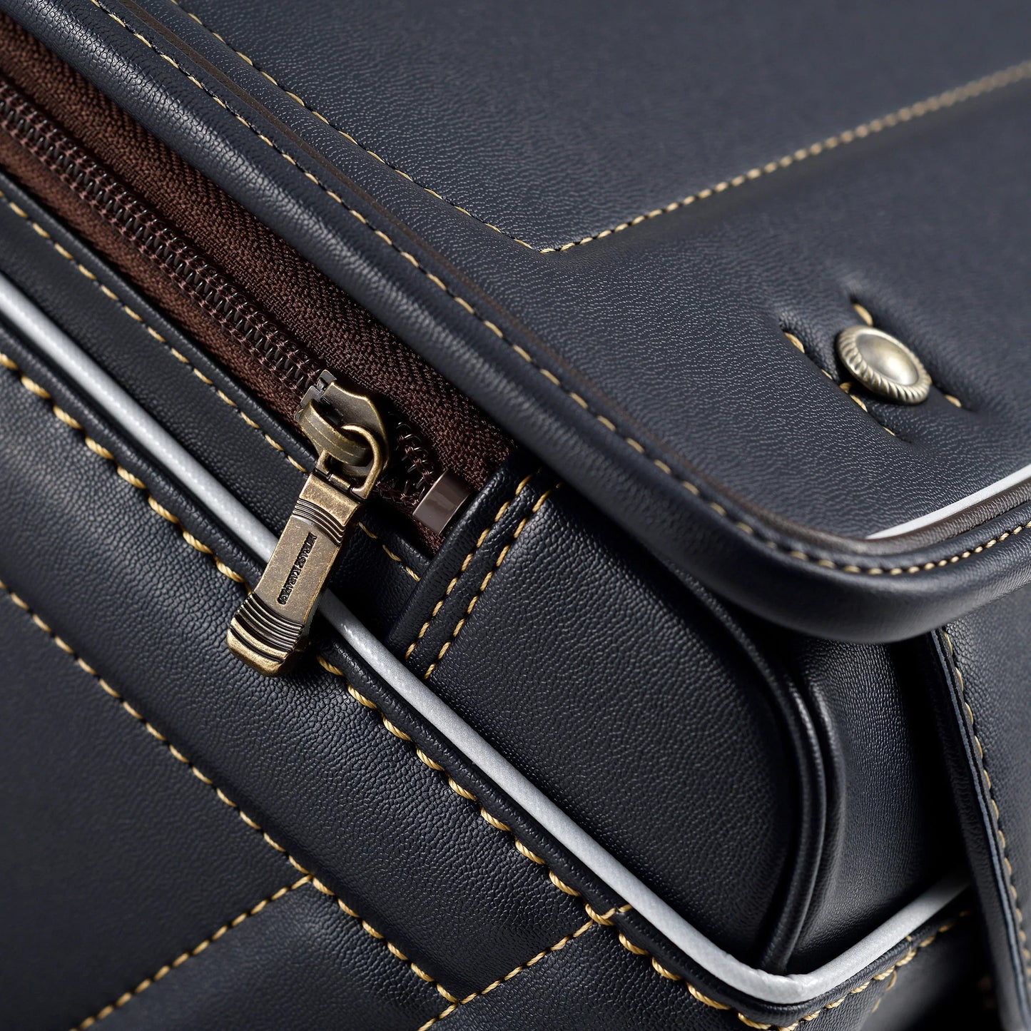 Close-up of black Japanese randoseru backpack with yellow stitching and metal zipper