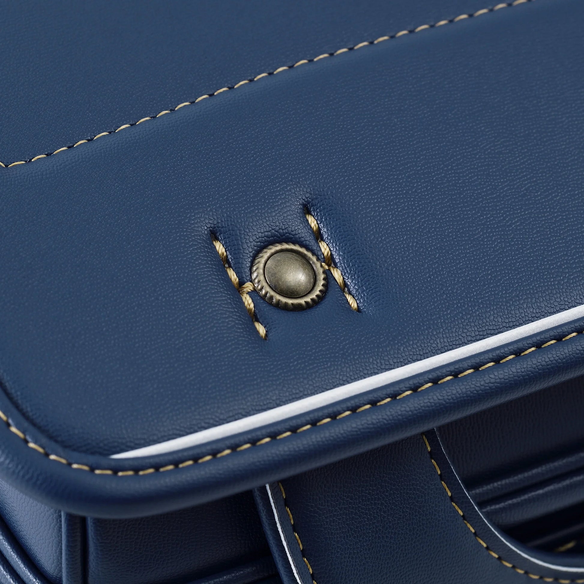 Close-up of blue Japanese randoseru backpack with contrast stitching and metal button