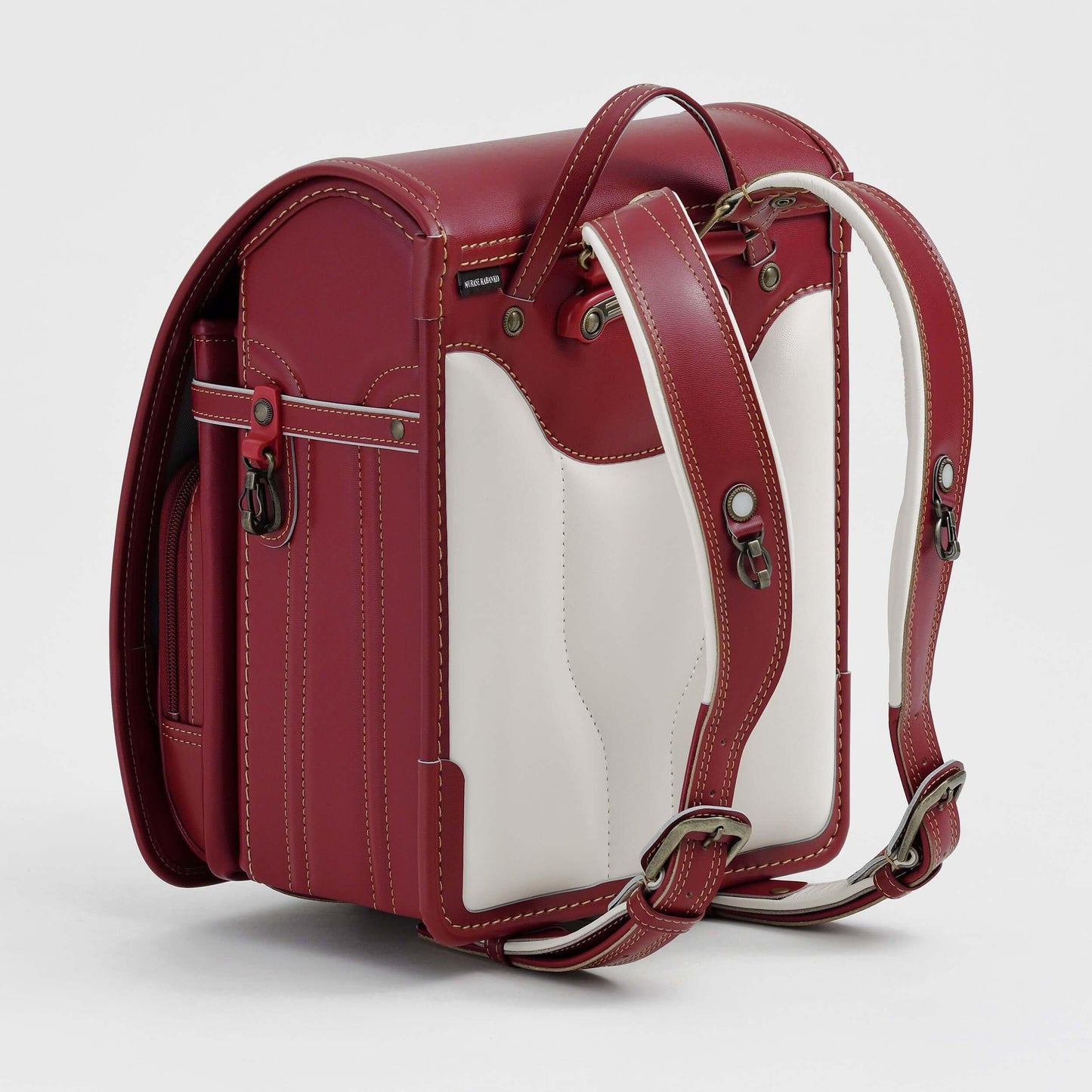 Randoseru Bolca Leather backpack in red with white panels by Murase Kabanko