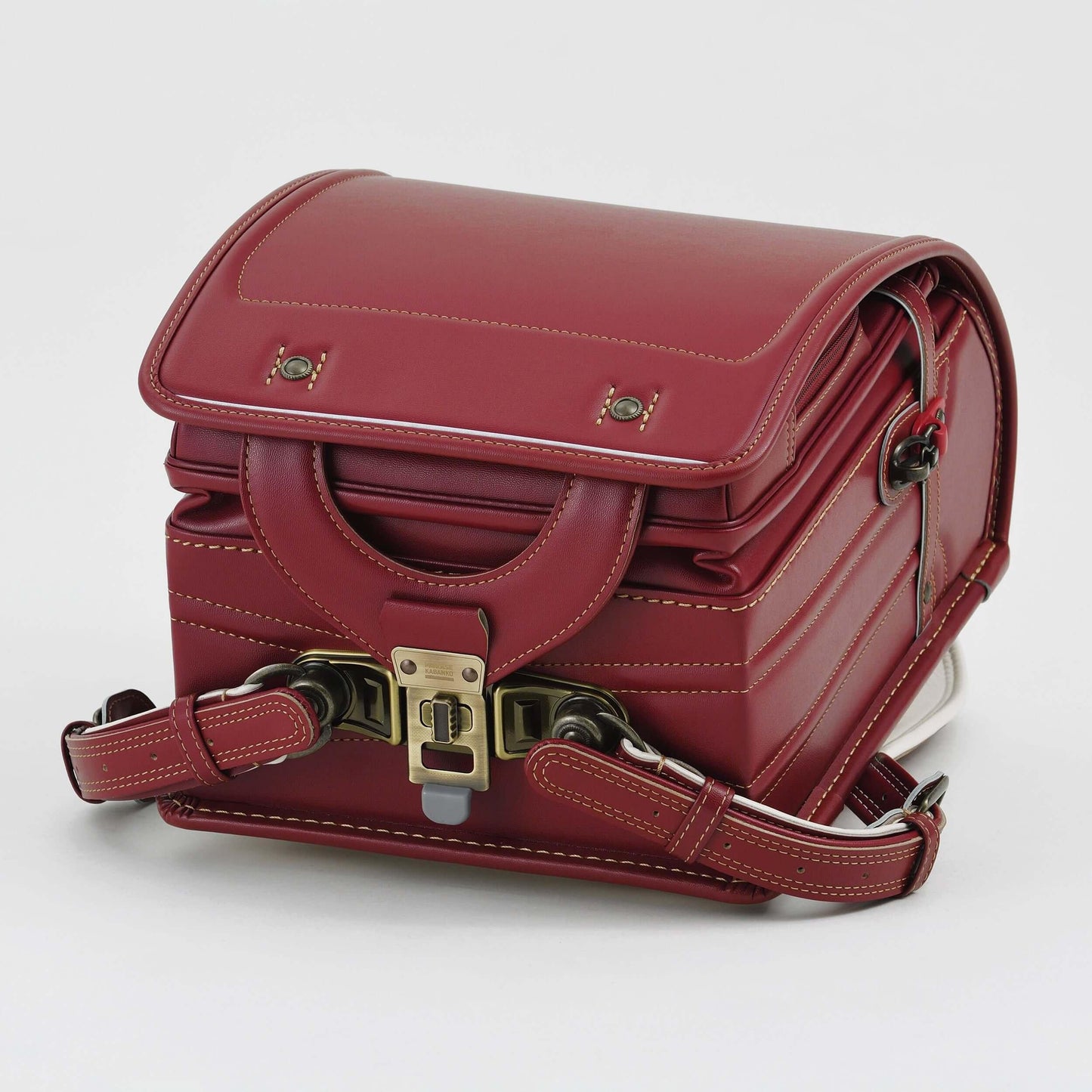 Randoseru Bolca Leather Backpack in red by Murase Kabanko with brass buckle and detailed stitching