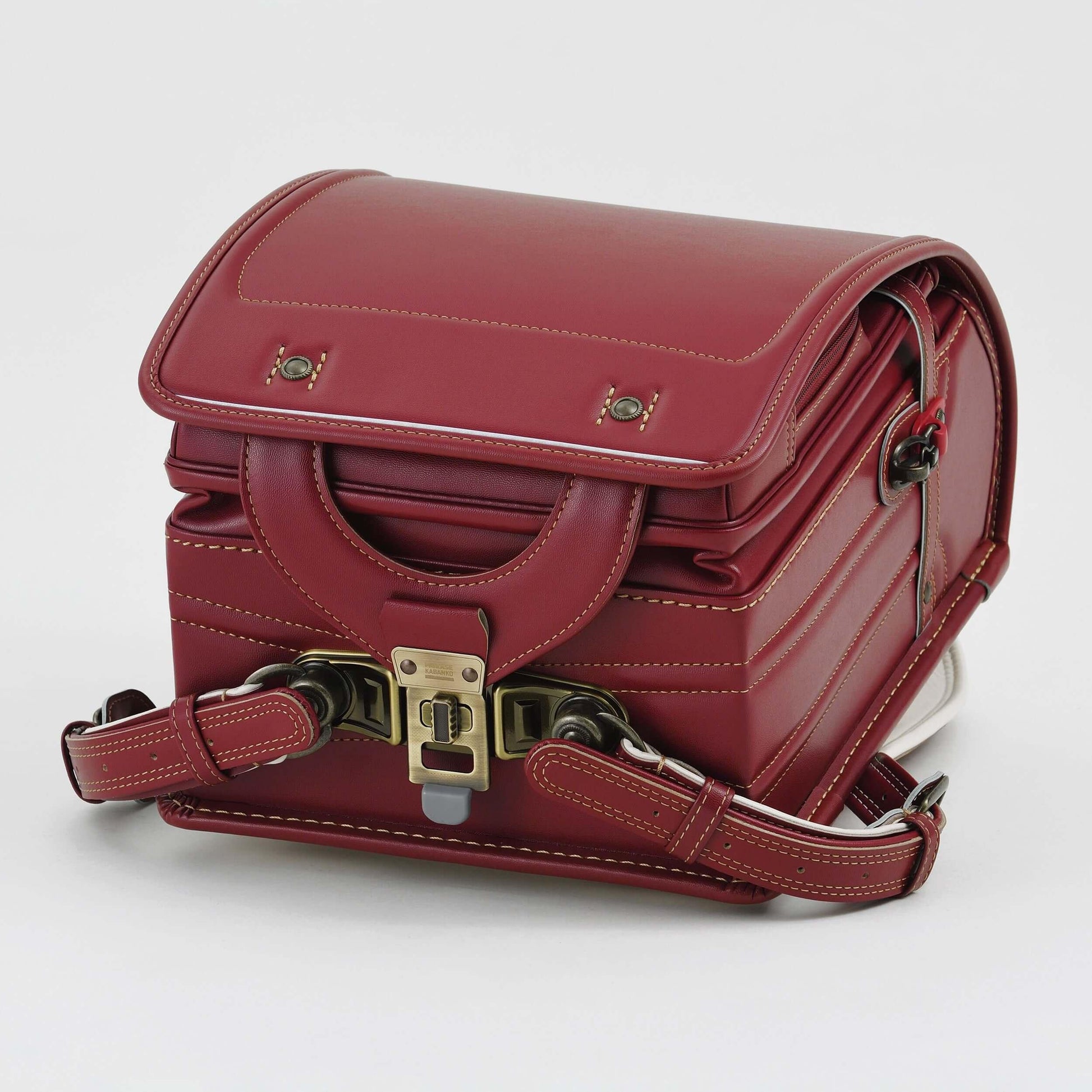 Randoseru Bolca Leather Backpack in red by Murase Kabanko with brass buckle and detailed stitching